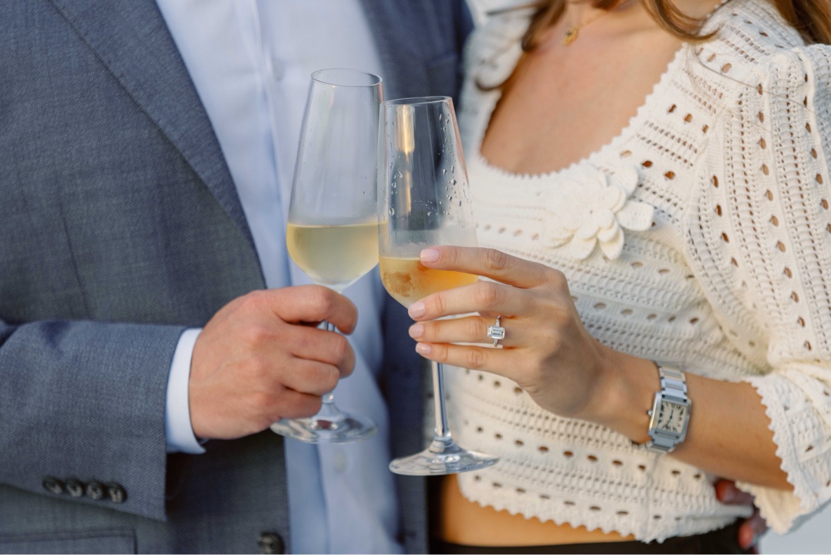 Champagne toast close-up with a new engagement ring after a surprise proposal on Long Island