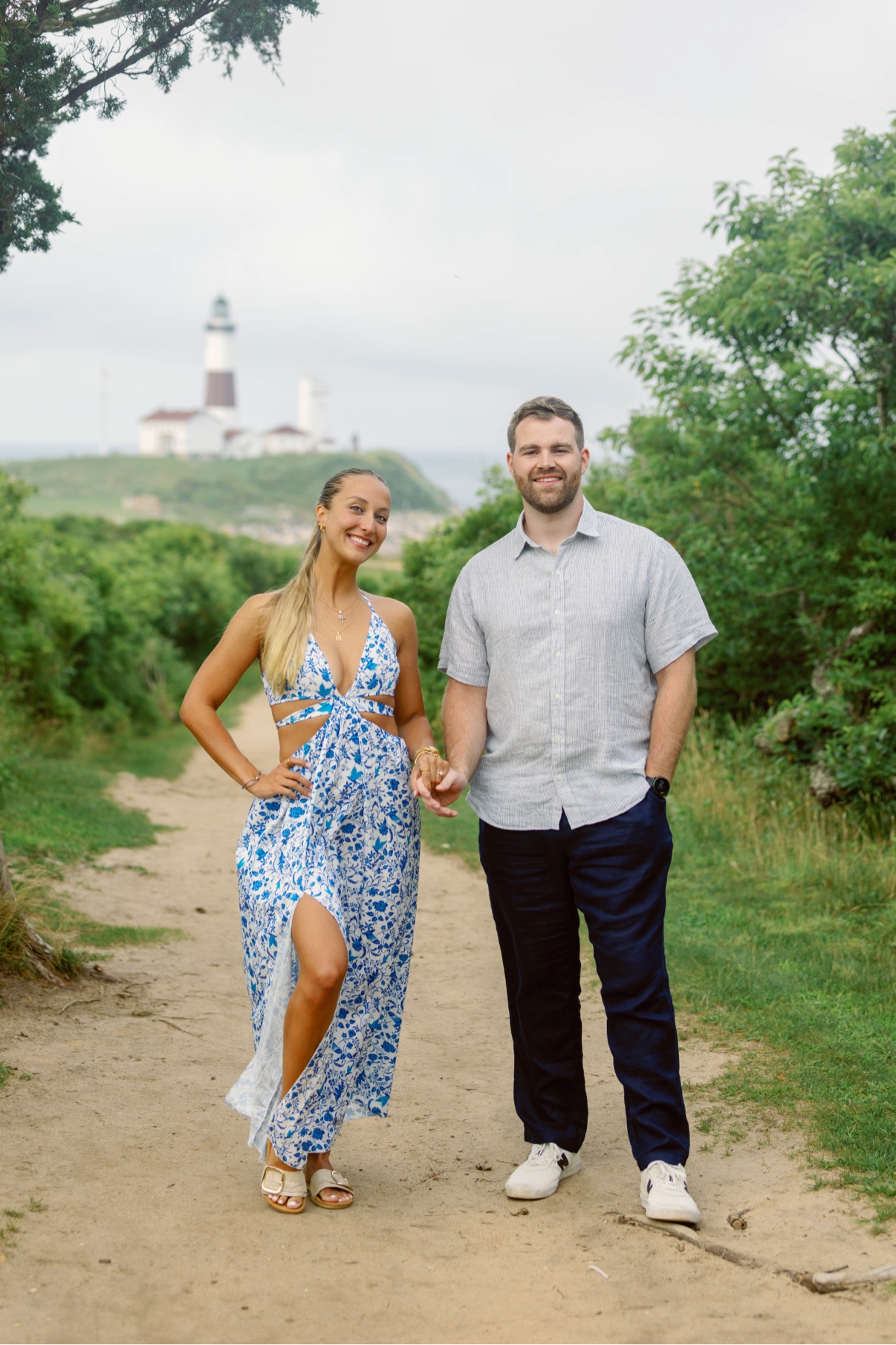 Couple holding hands on the path below Montauk Lighthouse, Long Island
