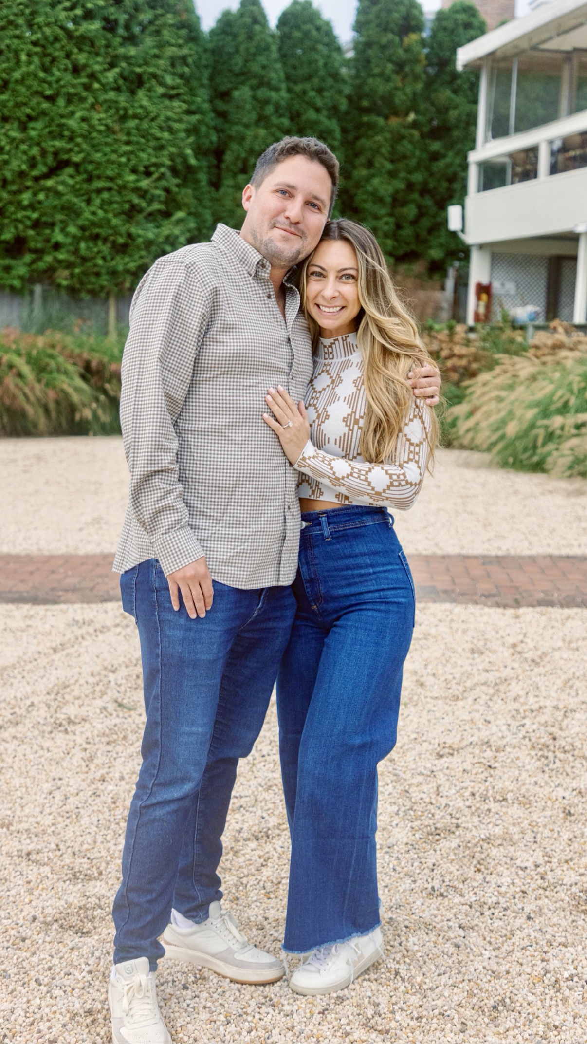 Engagement photos in Sag Harbor, Long Island — a couple in a close hug, smiling just after she said yes