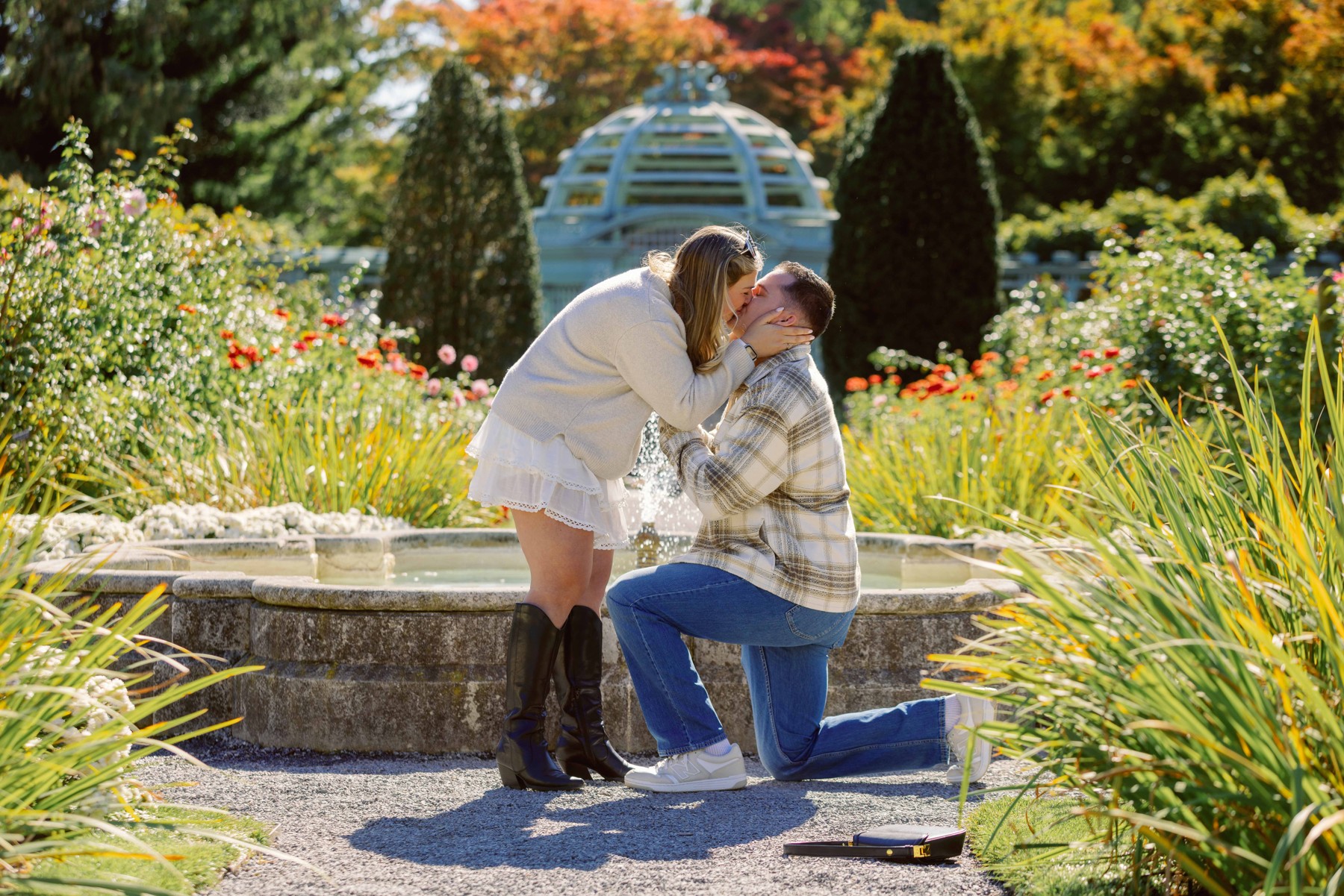 Surprise proposal at Old Westbury Gardens, Long Island — on one knee beside the rose garden fountain, the ring box open