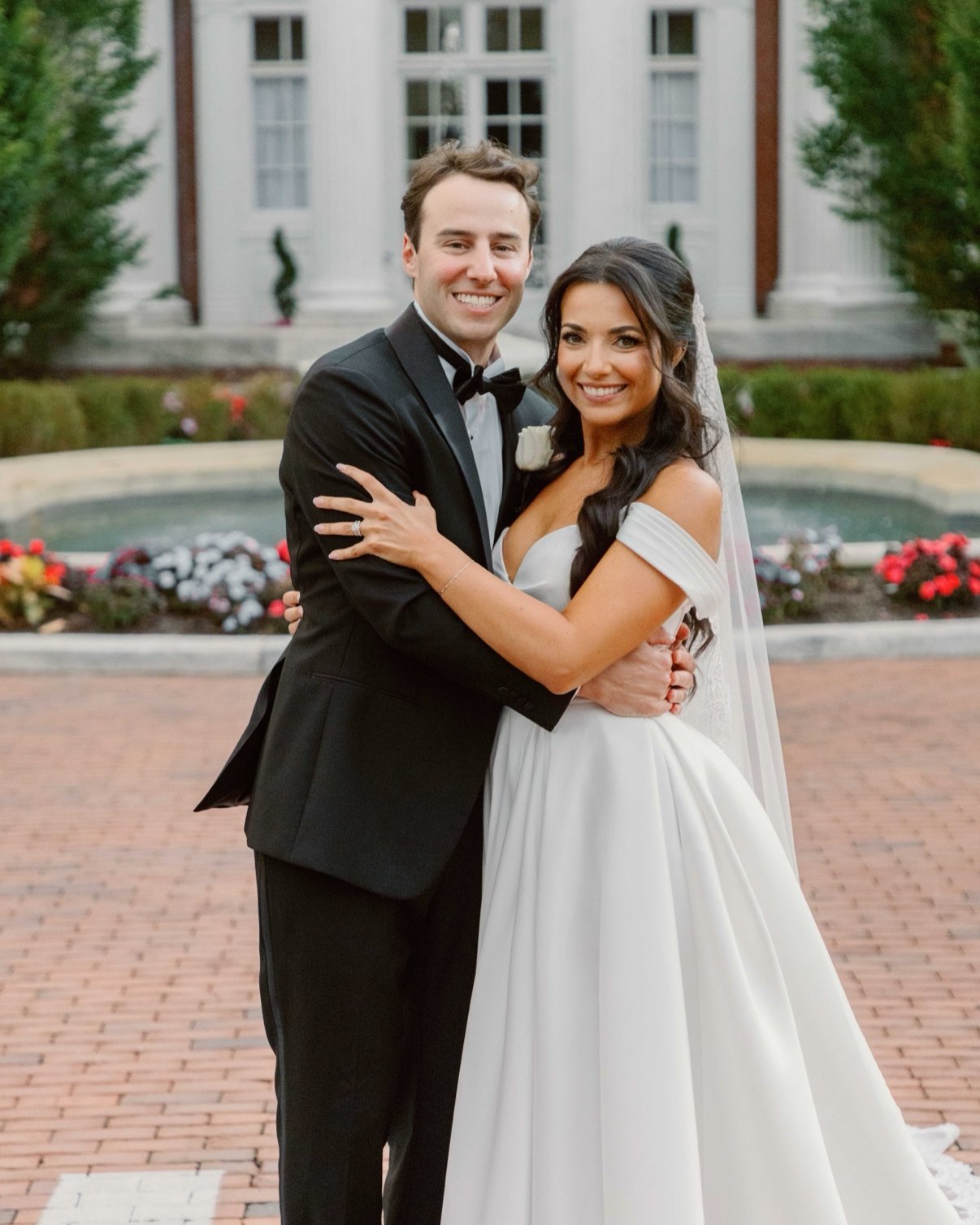 Newlyweds embracing in front of Bourne Mansion in Oakdale — Long Island wedding photographer