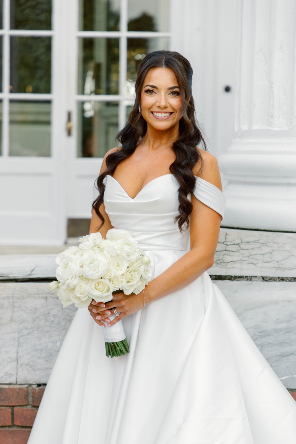 Bride holding white flowers outside Bourne Mansion in Oakdale — Long Island wedding photographer