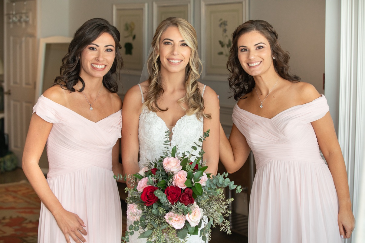 Bride with two bridesmaids, all smiling