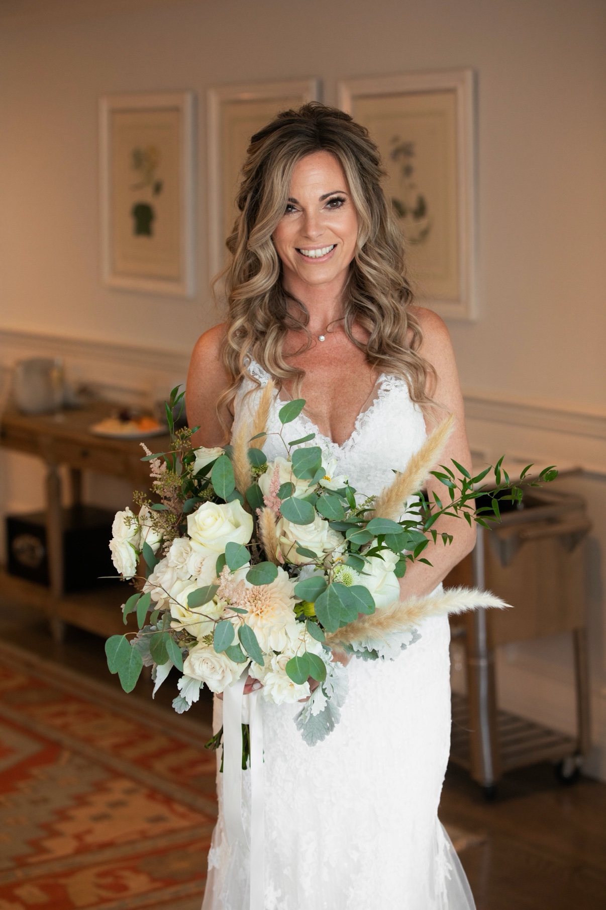 Bride smiling as she holds her bouquet at The Vineyards at Aquebogue